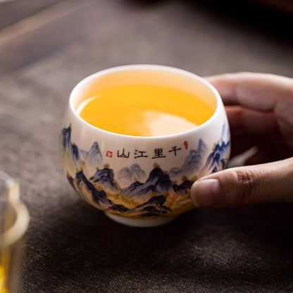 Tasse à thé en porcelaine remplie de thé vert, tenue en main