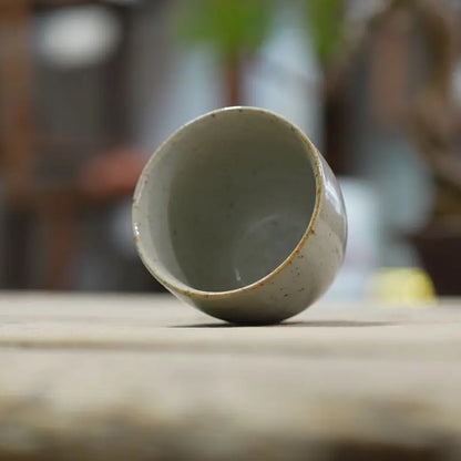 Tasse à thé inclinée laissant voir son intérieur émaillé blanc